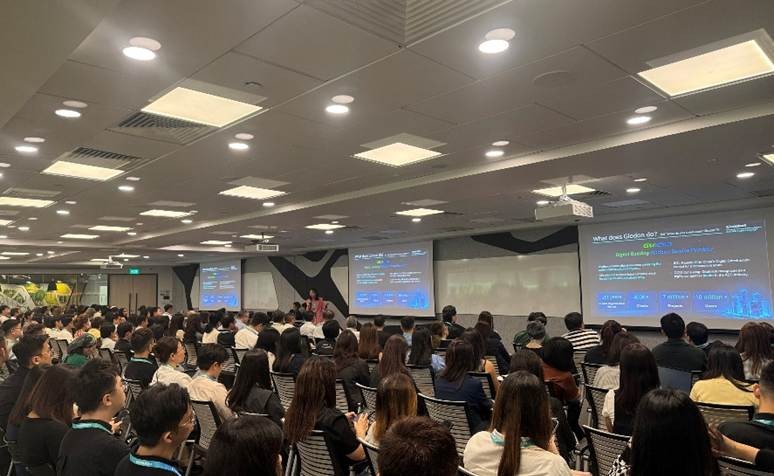 Participants engaged during a session showcasing Glodon’s strategies for AI-driven digital innovation, with slides projected on-screen.